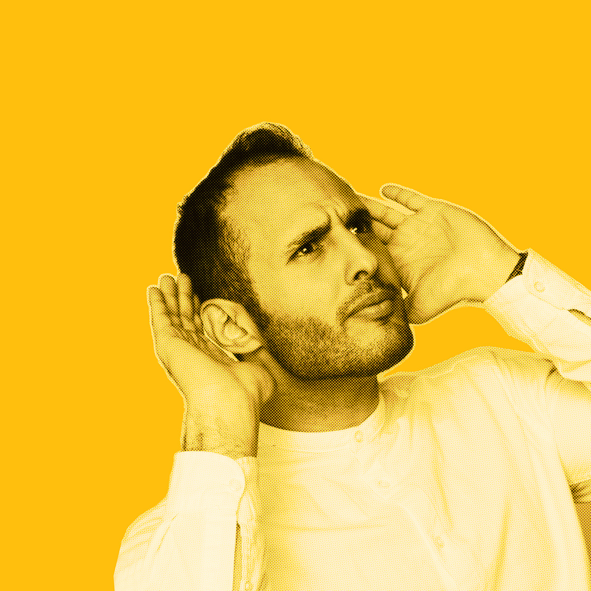 Yellow-filtered picture of man looking to the side holding his hands behind his ears